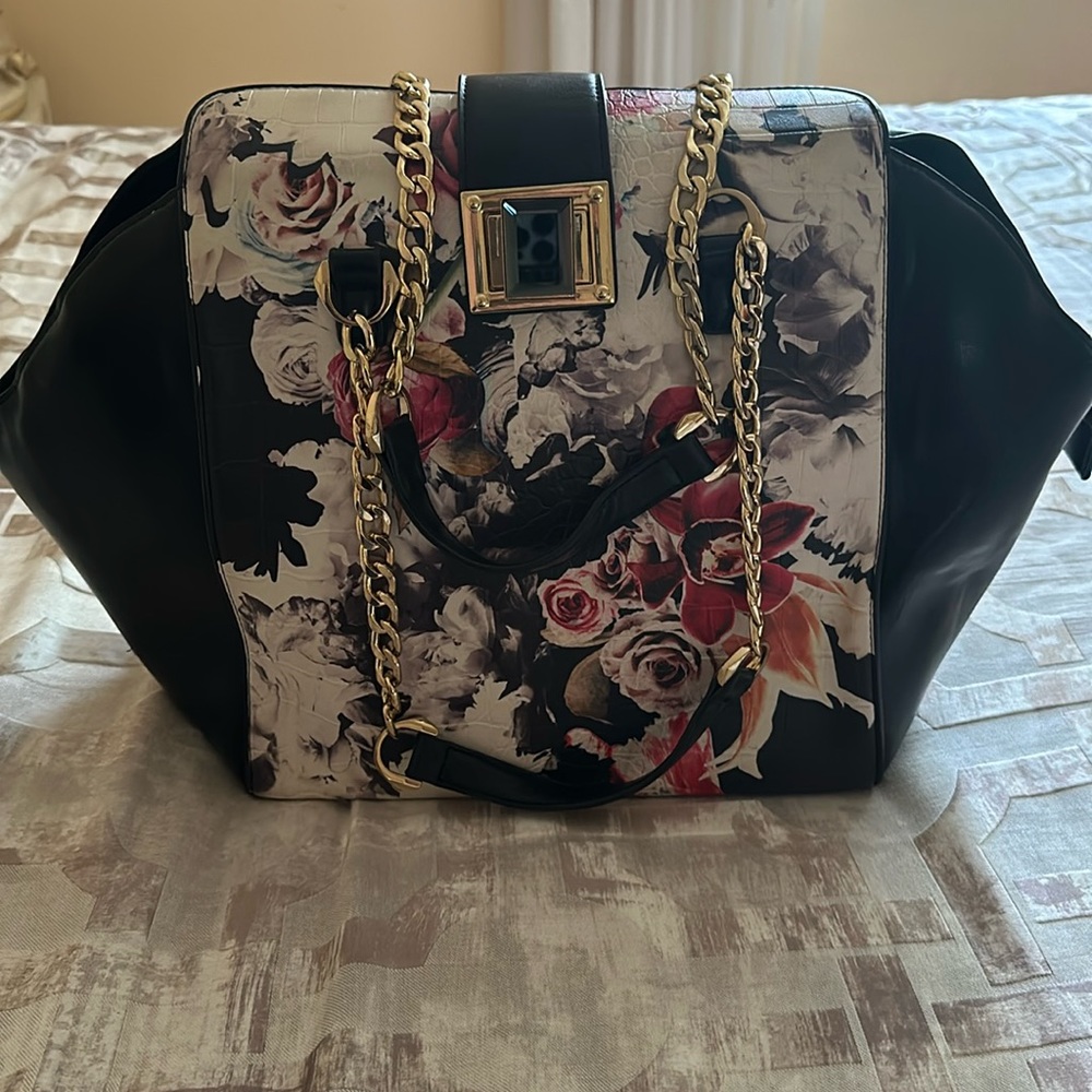 Bebe leather bag with floral design, gold accent chain handle. Good condition.